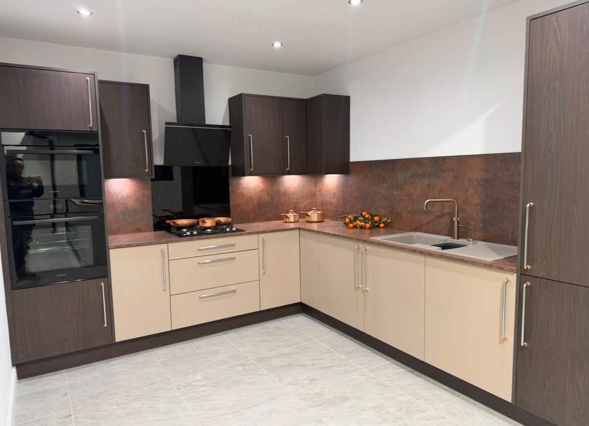 Two-tone fitted kitchen with warm metallic details