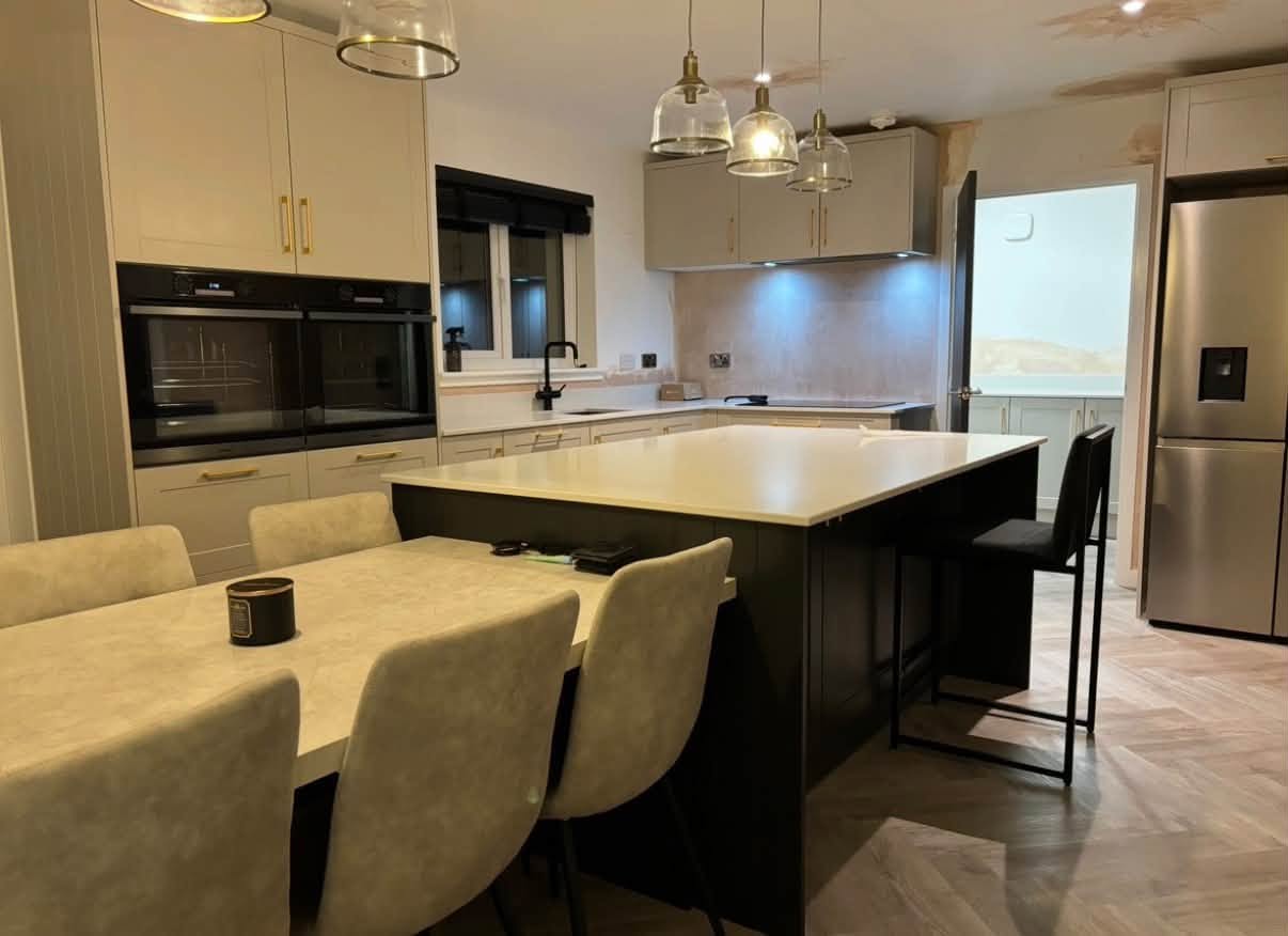 Warm two-tone kitchen installation with central island and dining area