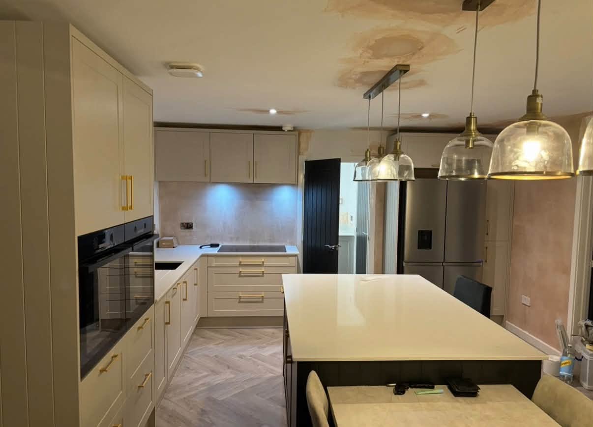 Completed kitchen with island, pendant lighting and integrated appliances